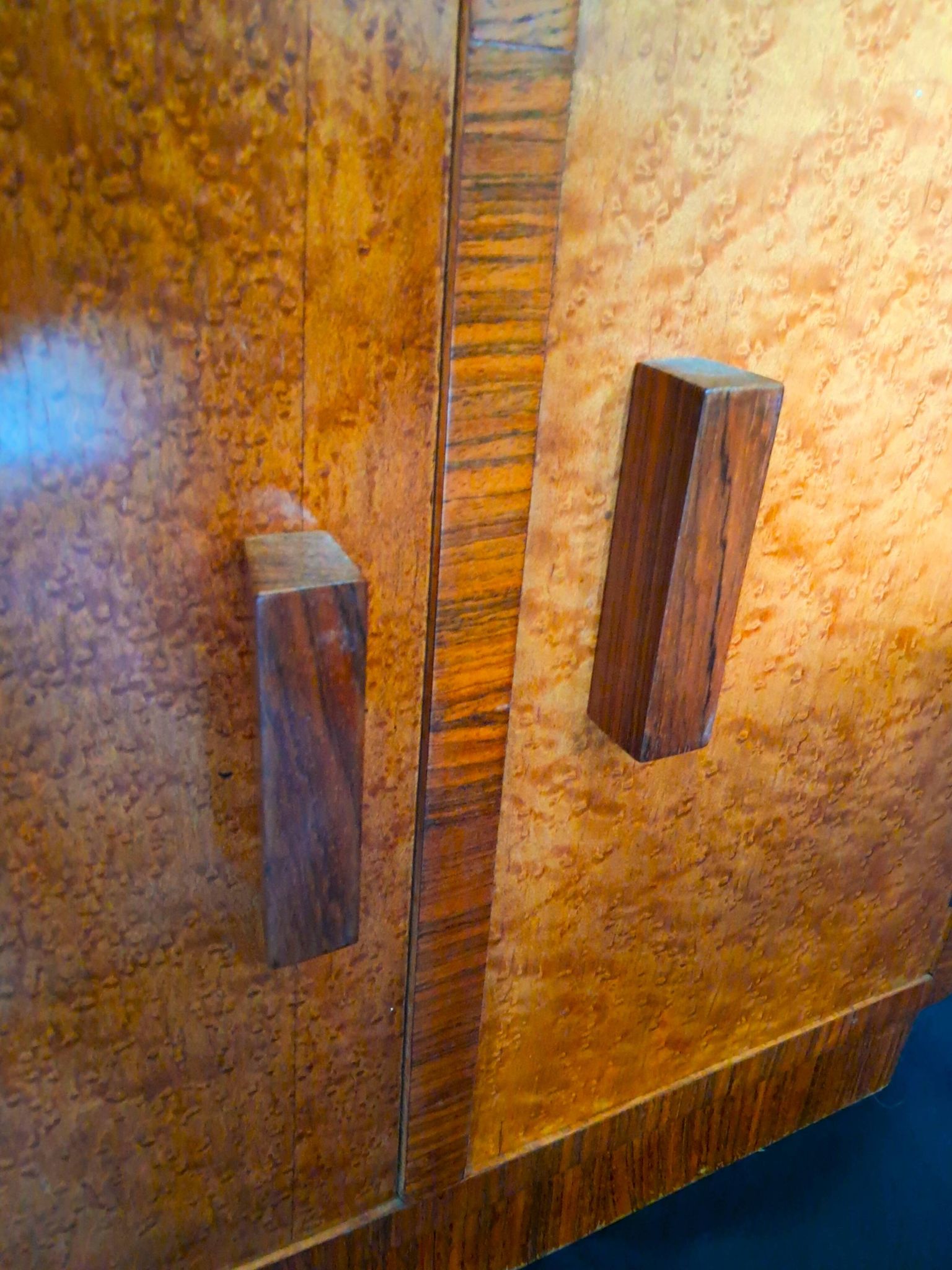 Art Deco cabinet in speckled maple veneer with asymmetrical shelves.
