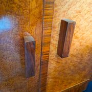 Art Deco cabinet in speckled maple veneer with asymmetrical shelves.