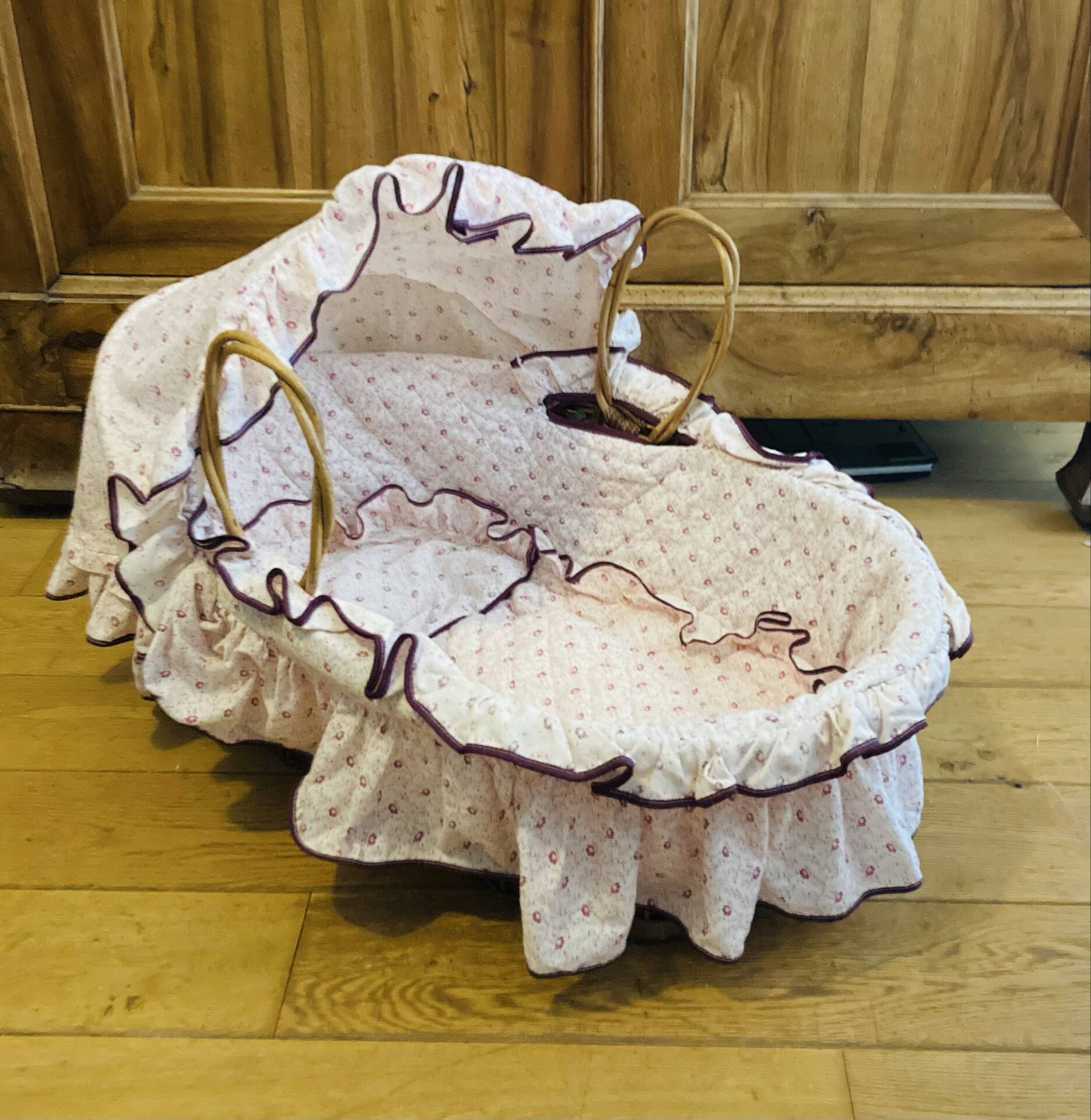 1960s wicker cradle with mattress and drapes.