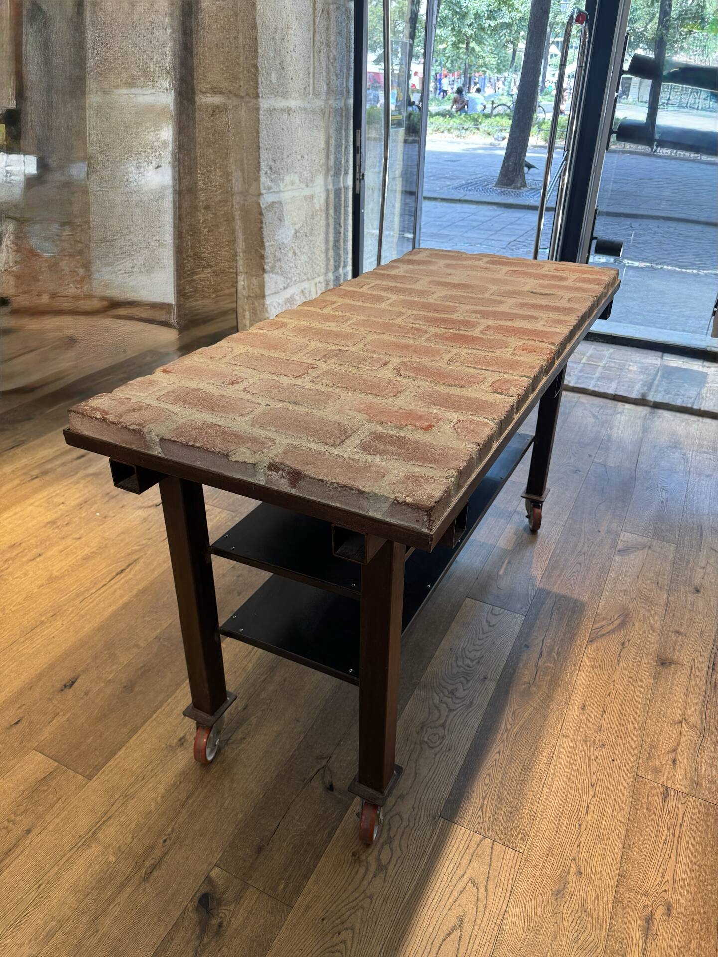 Industrial style creator table in bricks and metal on wheels.
