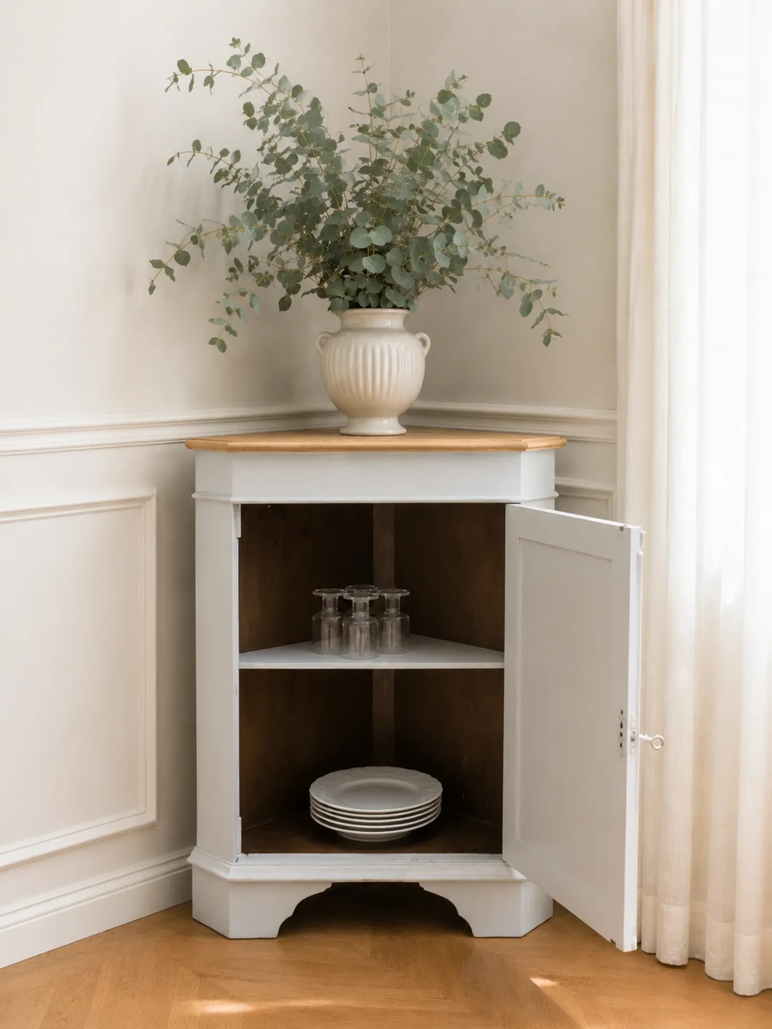 Vintage English corner cabinet enhanced in pearl grey, wooden top.