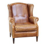 Graceful, stylish, timeless and comfortable wing chair made of cowhide in English style