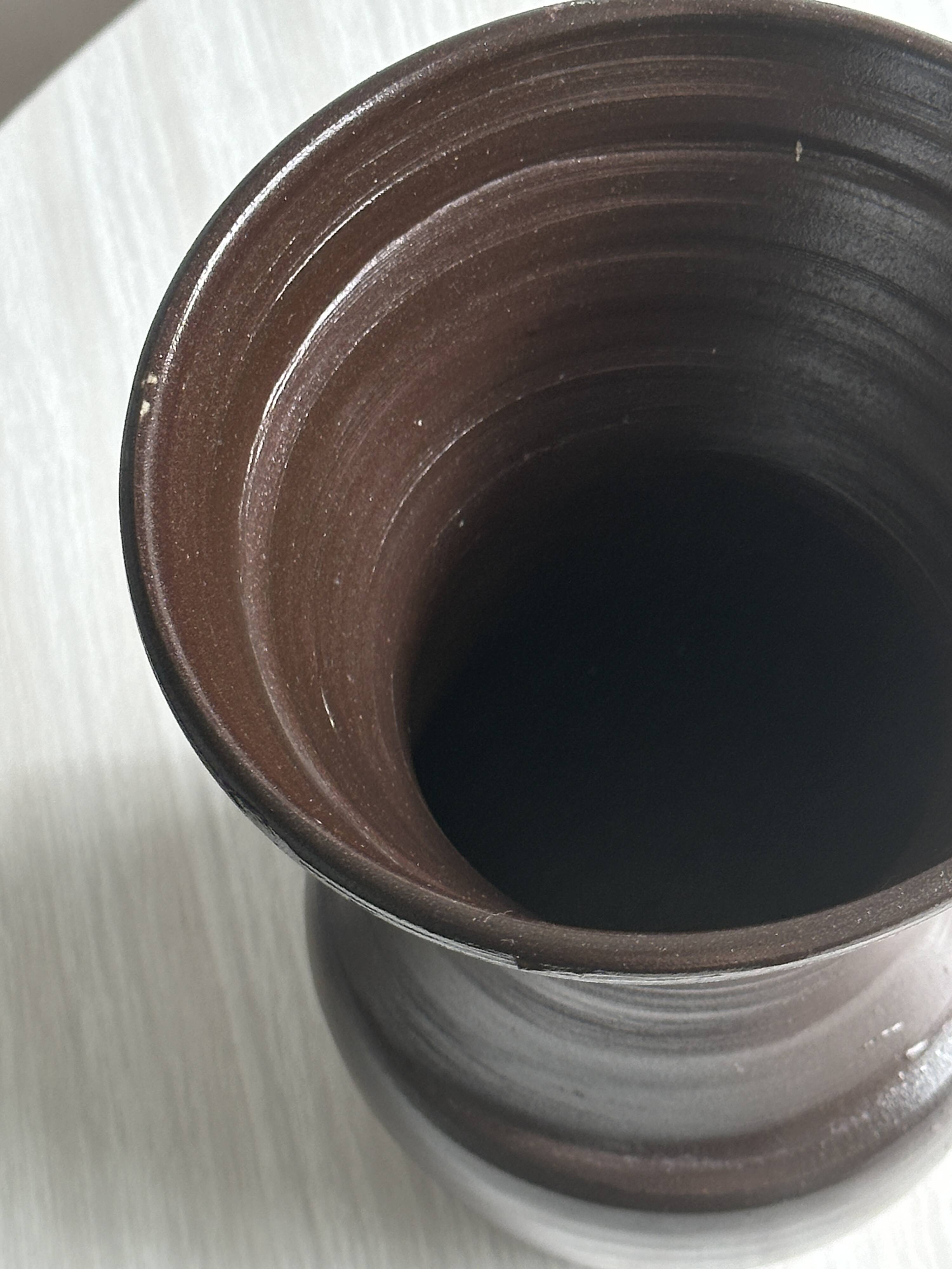 Dark brown ceramic vase, flared shape, smooth finish, classic style