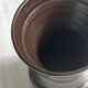 Dark brown ceramic vase, flared shape, smooth finish, classic style