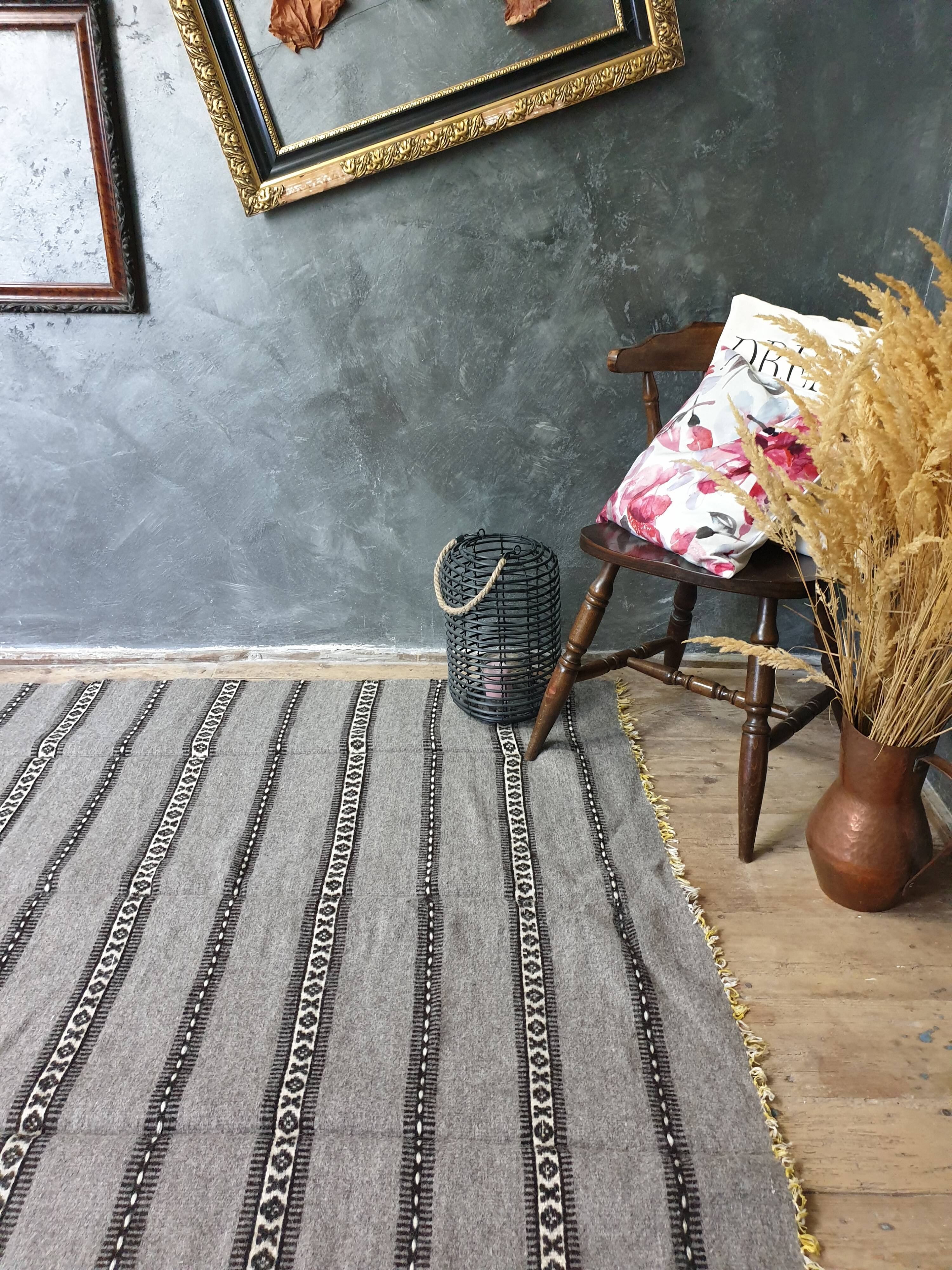 Handwoven vintage geometrical rug, grey background