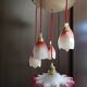 Suspension with tulips and a red scalloped lampshade.