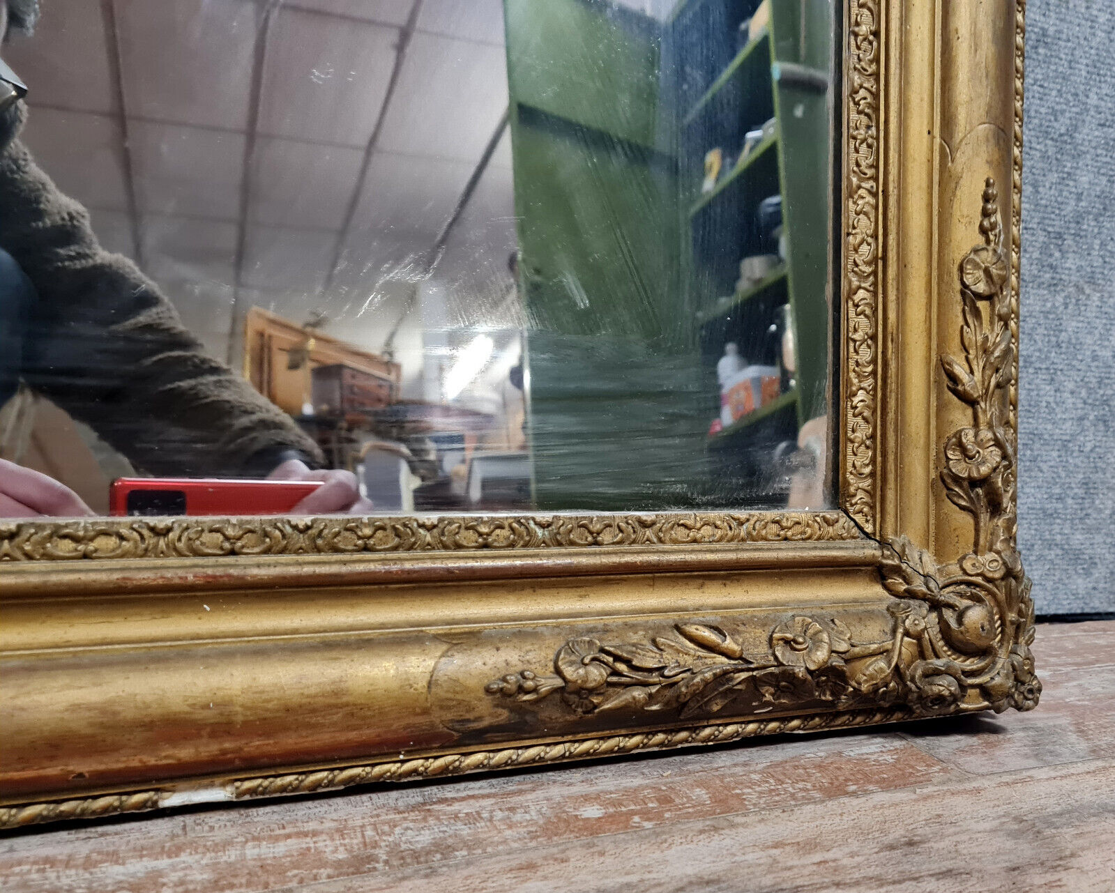 Old nineteenth century mirror in gilded wood and carved around 1850