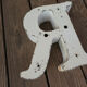 Letter "R" of vintage industrial brand in iron