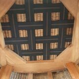 Armchair in woven rattan and exotic wood