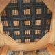 Armchair in woven rattan and exotic wood