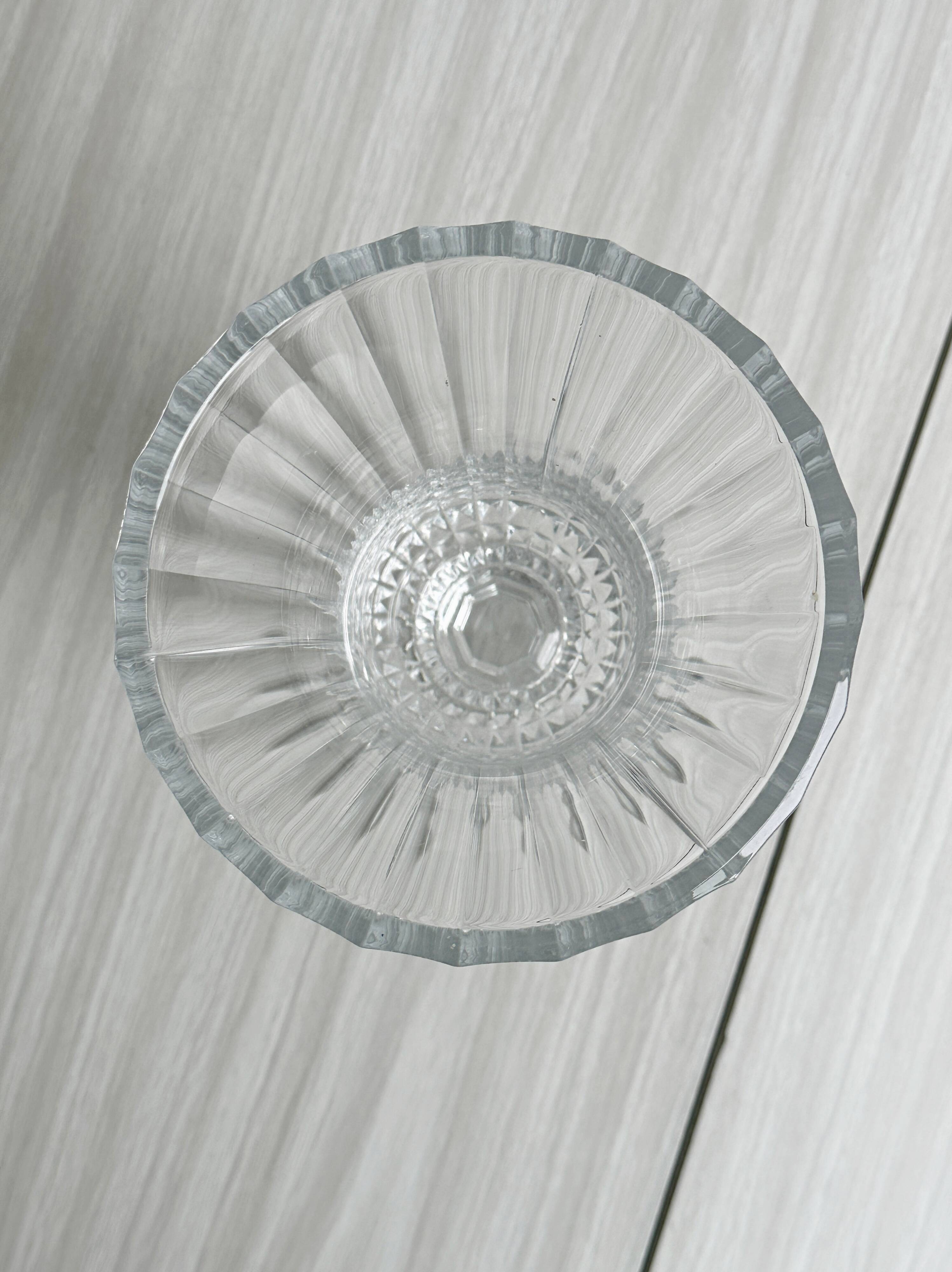 Antique thick glass vase on a pedestal.