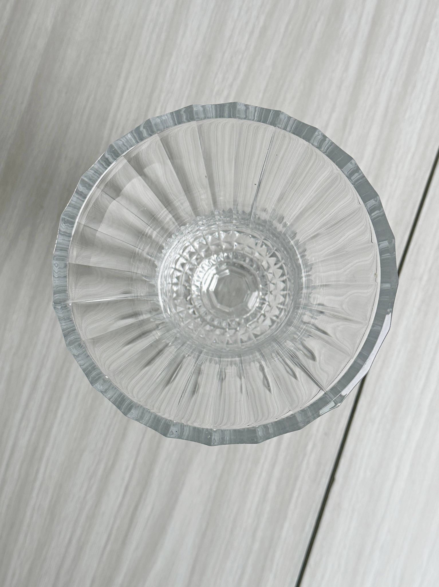 Antique thick glass vase on a pedestal.