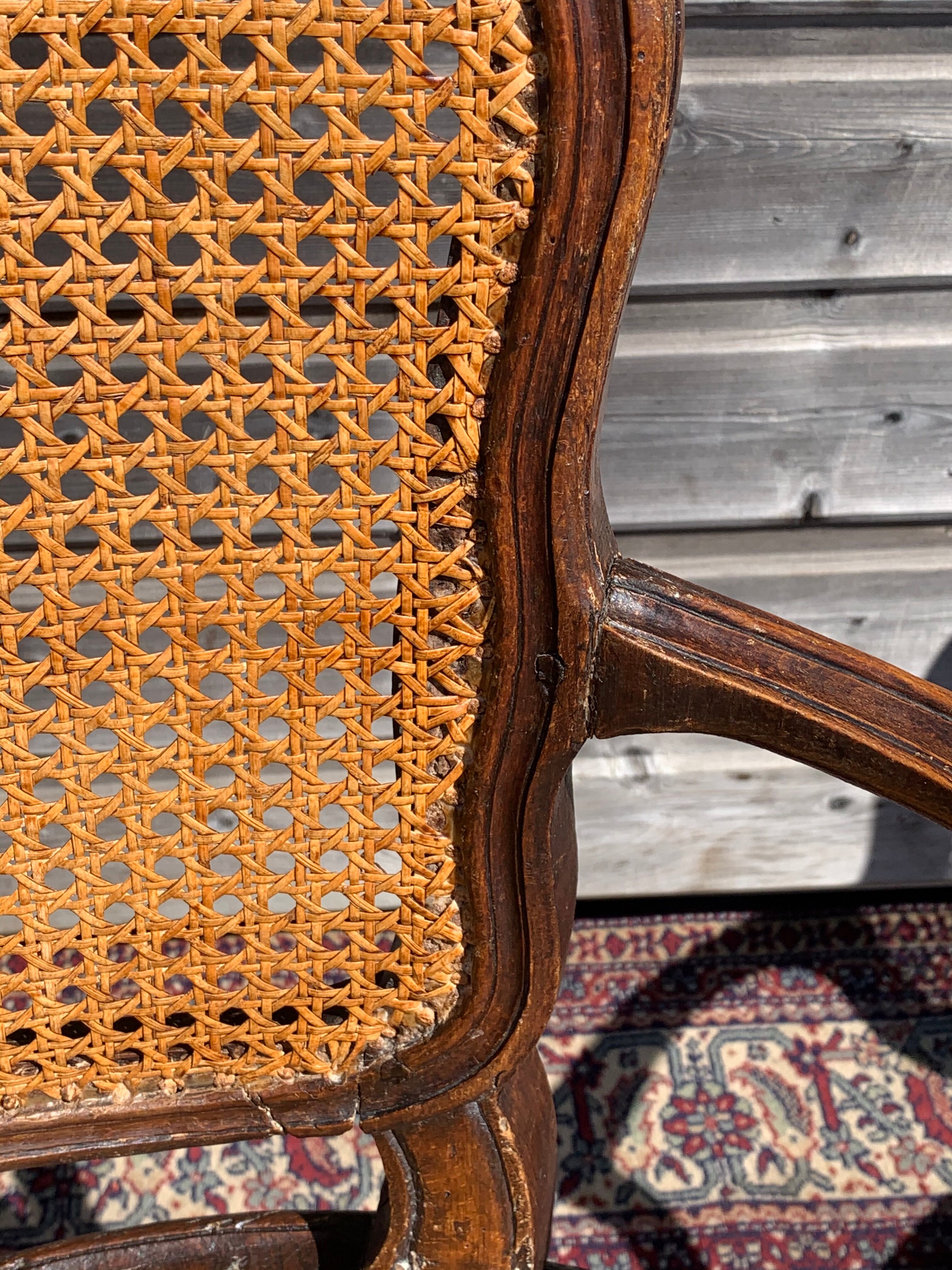 Pair of caned convertible armchairs Louis XV period