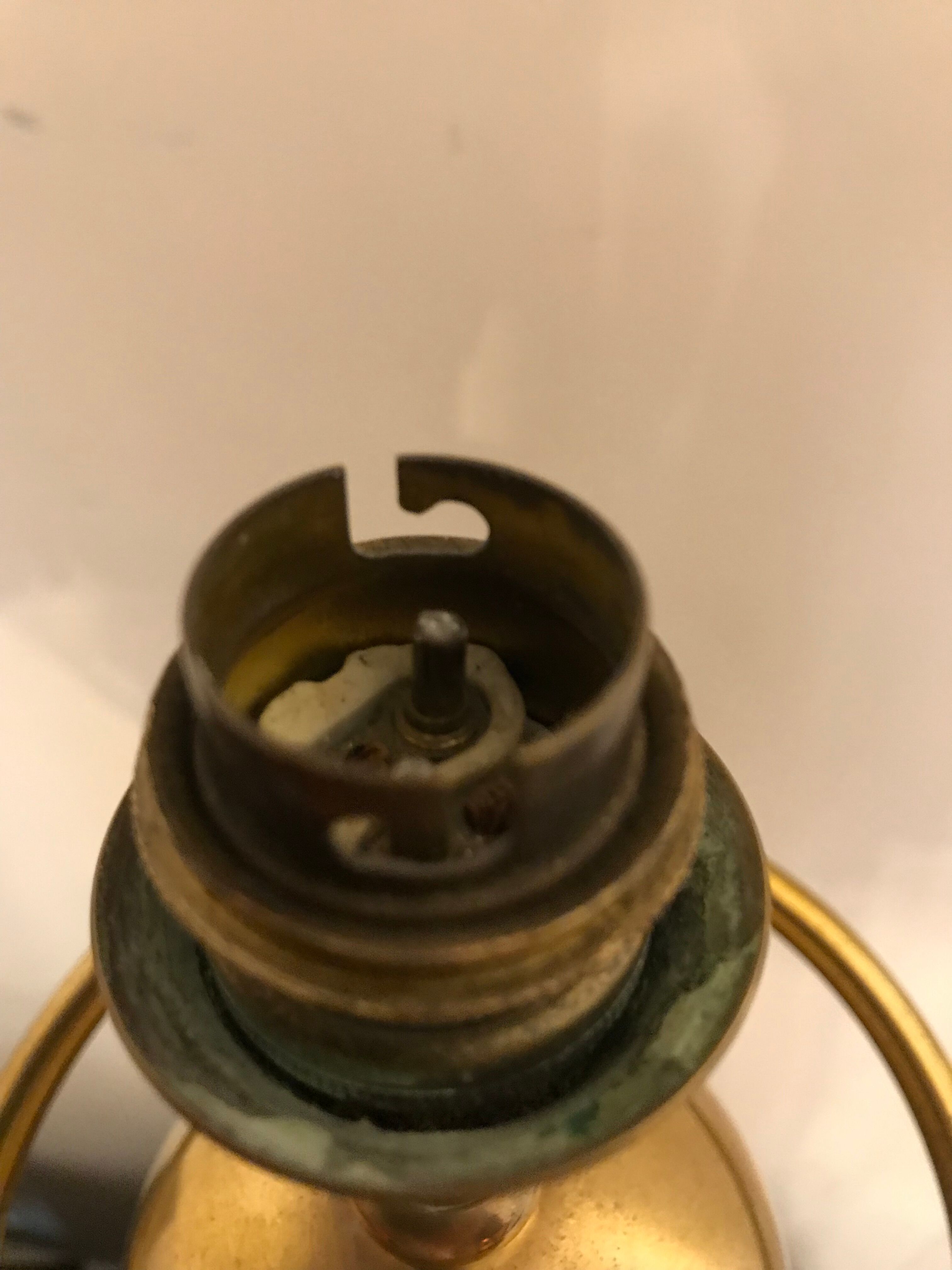 Brass lamp with removable ring around a globe