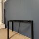 Black metal console with glass top