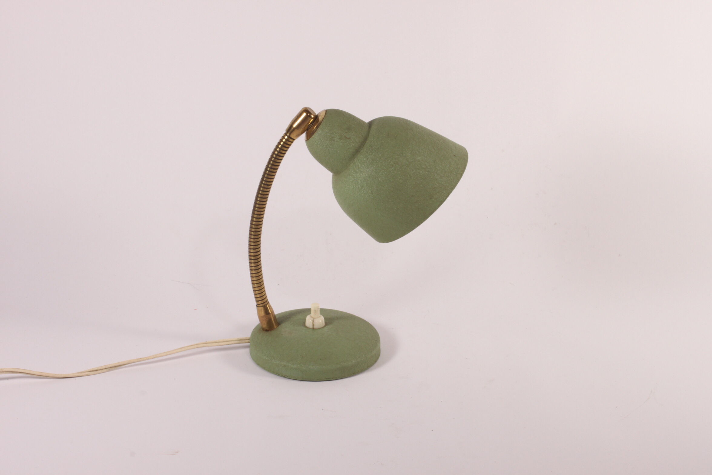 Flexible brass and green metal bedside lamp, 1950s.