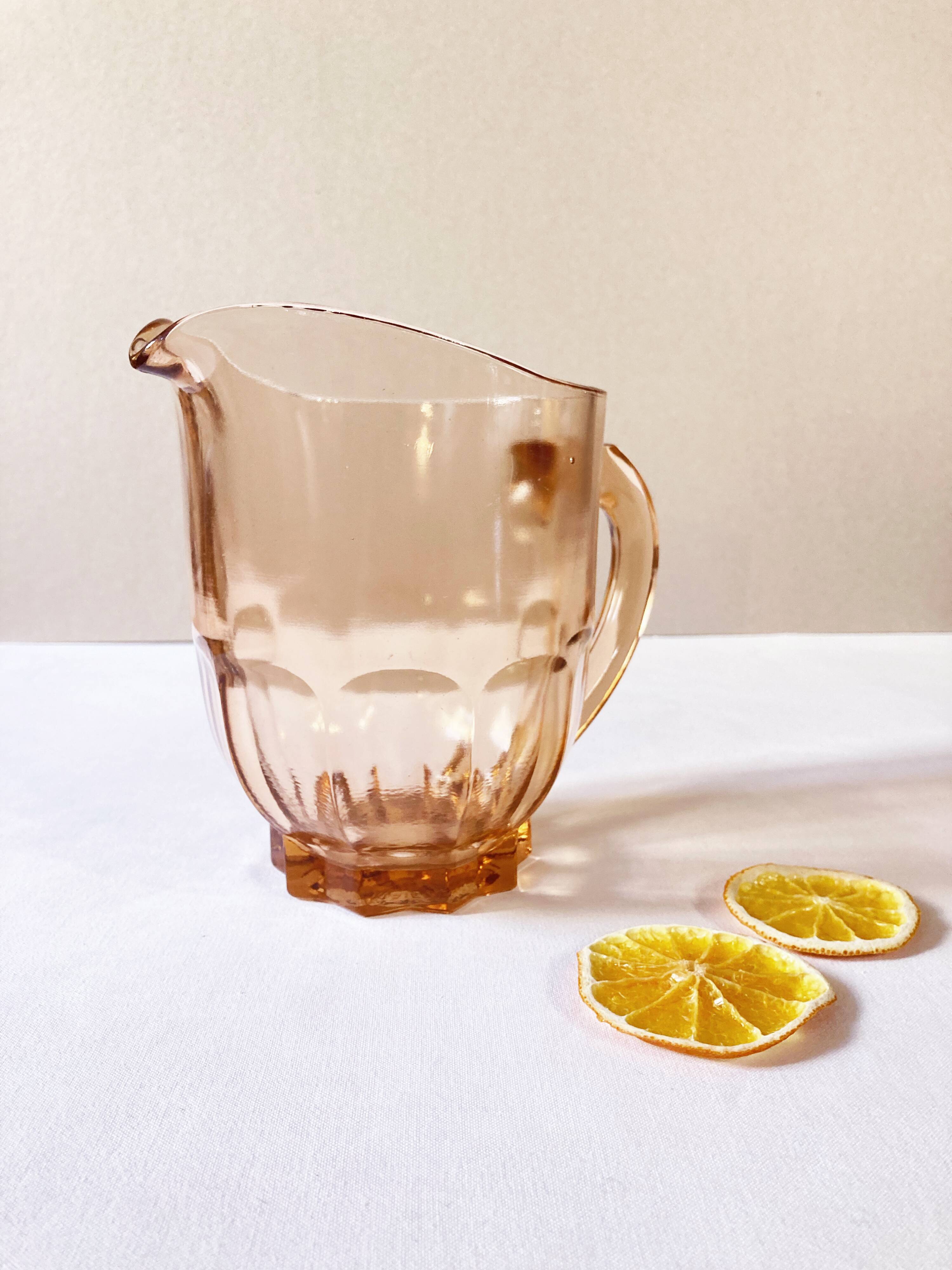 Pitcher and 6 water glasses in pink glass