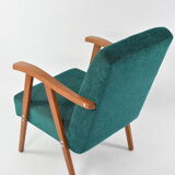 Green curved armchair