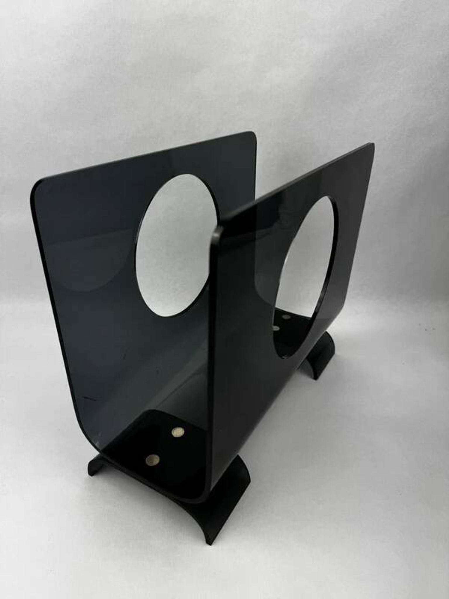 Vintage 1970s smoked plexiglass magazine rack, minimalist design.