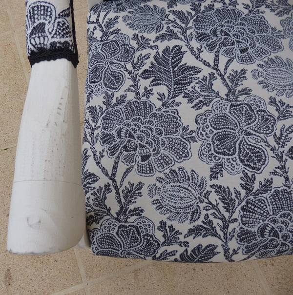 Voltaire style armchair covered in floral fabric in quality aged wood