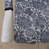 Voltaire style armchair covered in floral fabric in quality aged wood