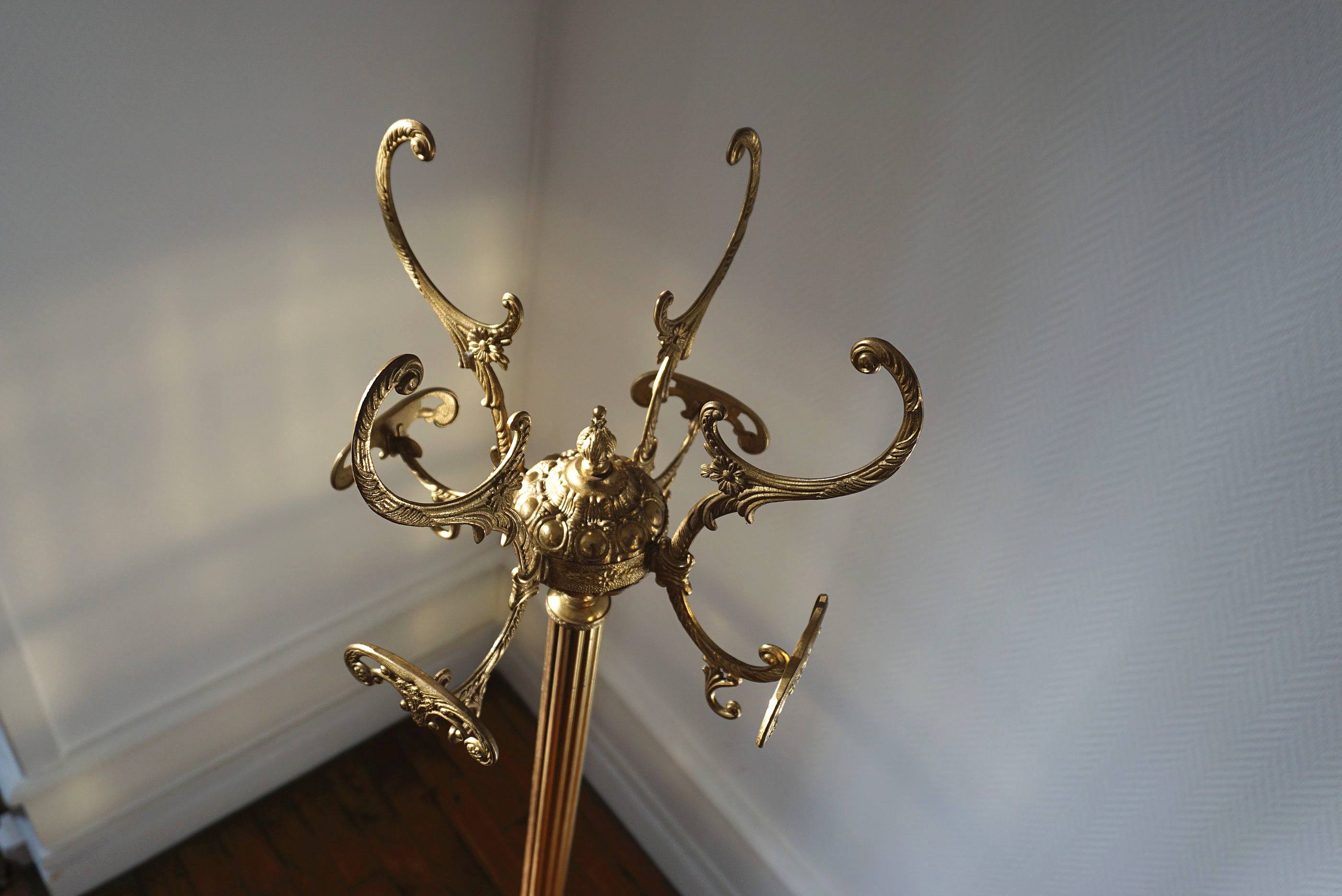 Turning brass coat rack