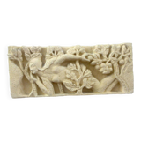 Sculpted stone wall decoration, medieval motif: Eve in the Garden of Eden
