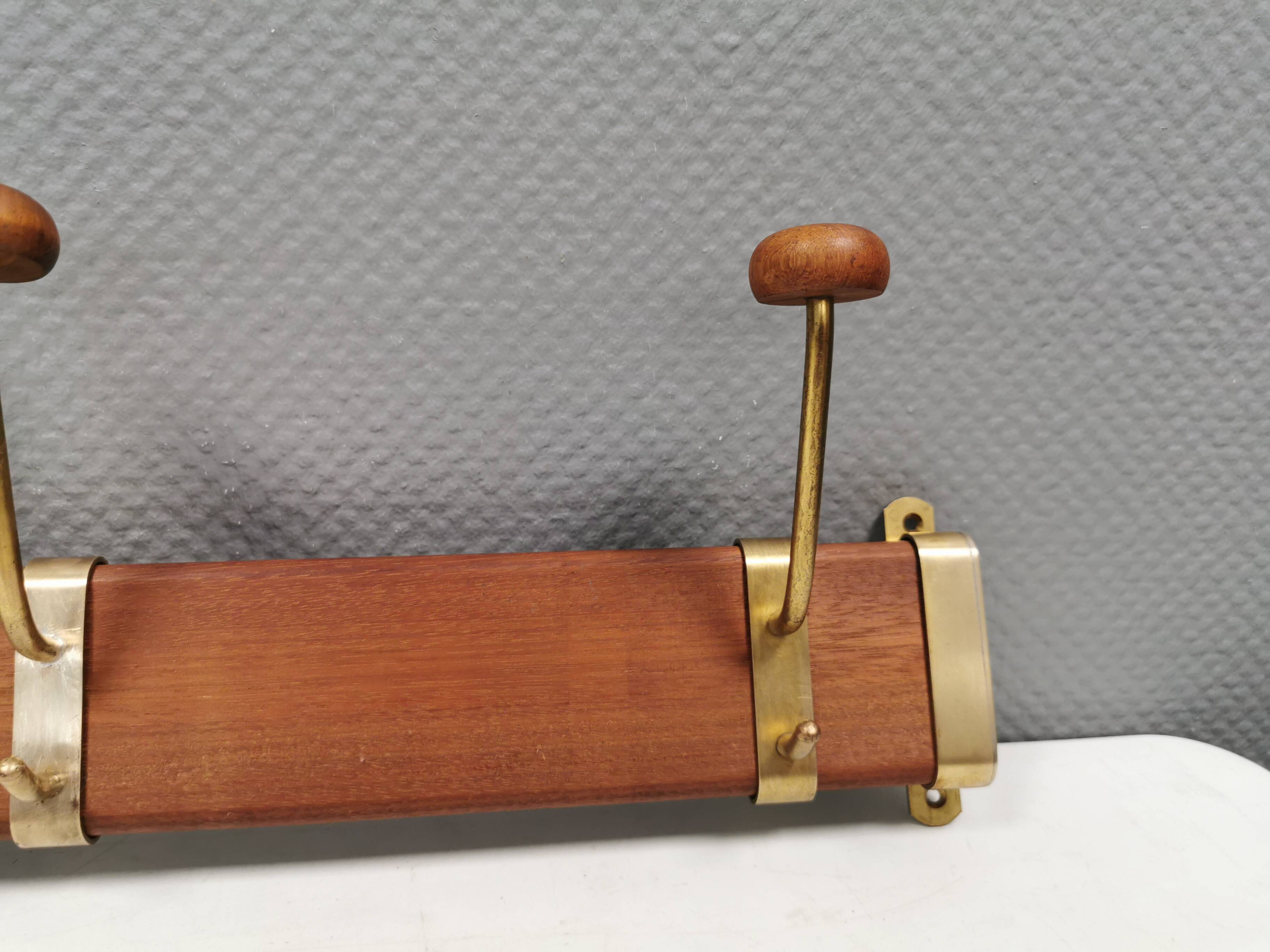 Danish teak and brass coat rack with adjustable hooks, 1960s.