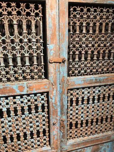 Openwork indian door in metal and blue wood