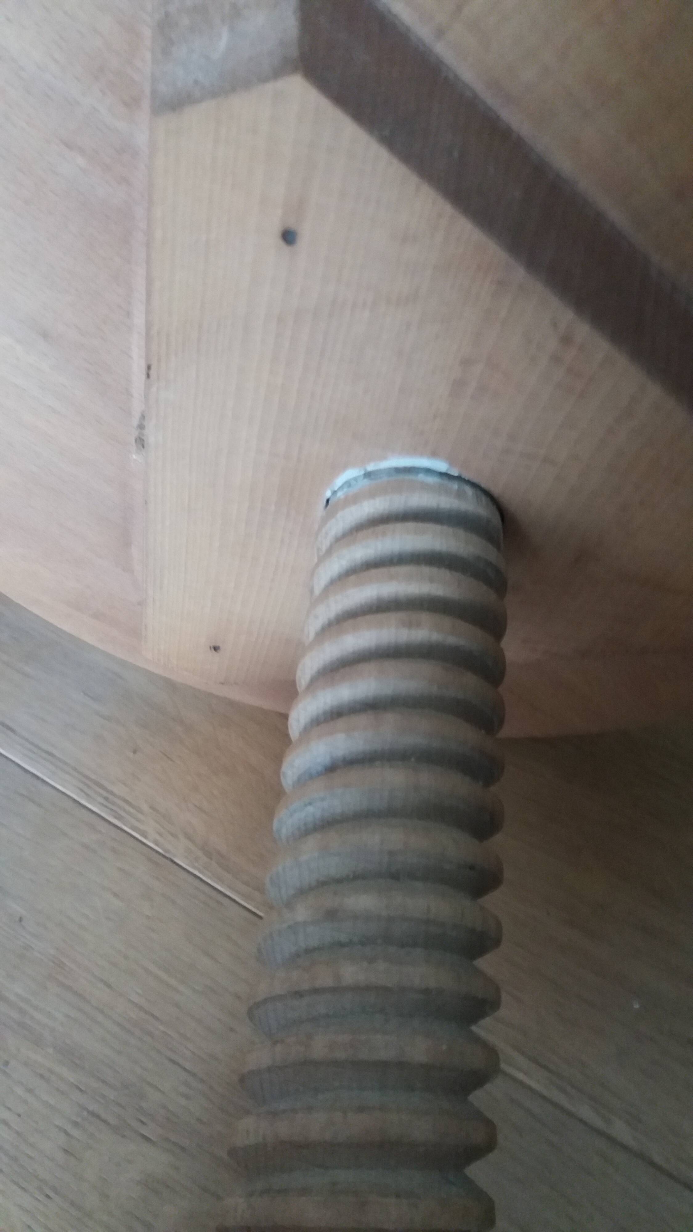Tripod stool with a screw.