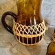Pitcher and amber glasses and rattan