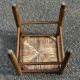 1950s turned wooden stool with a straw seat.