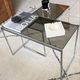 Set of 2 vintage nesting coffee tables in chrome metal and smoked glass.