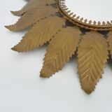 Old sun mirror with foliage in gilded metal with twisted frieze from the 60s