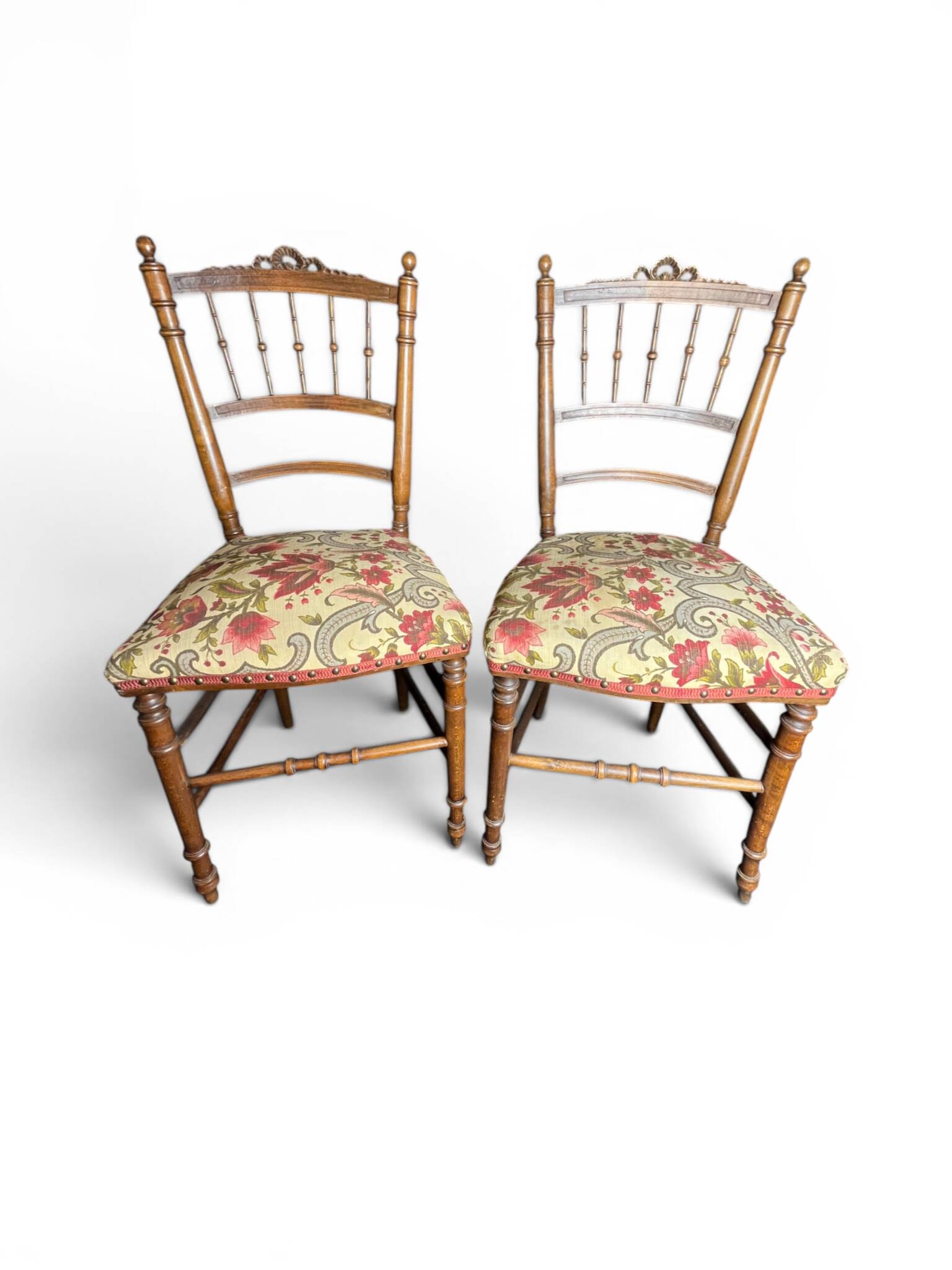 Two floral upholstered music chairs from the early 20th century.