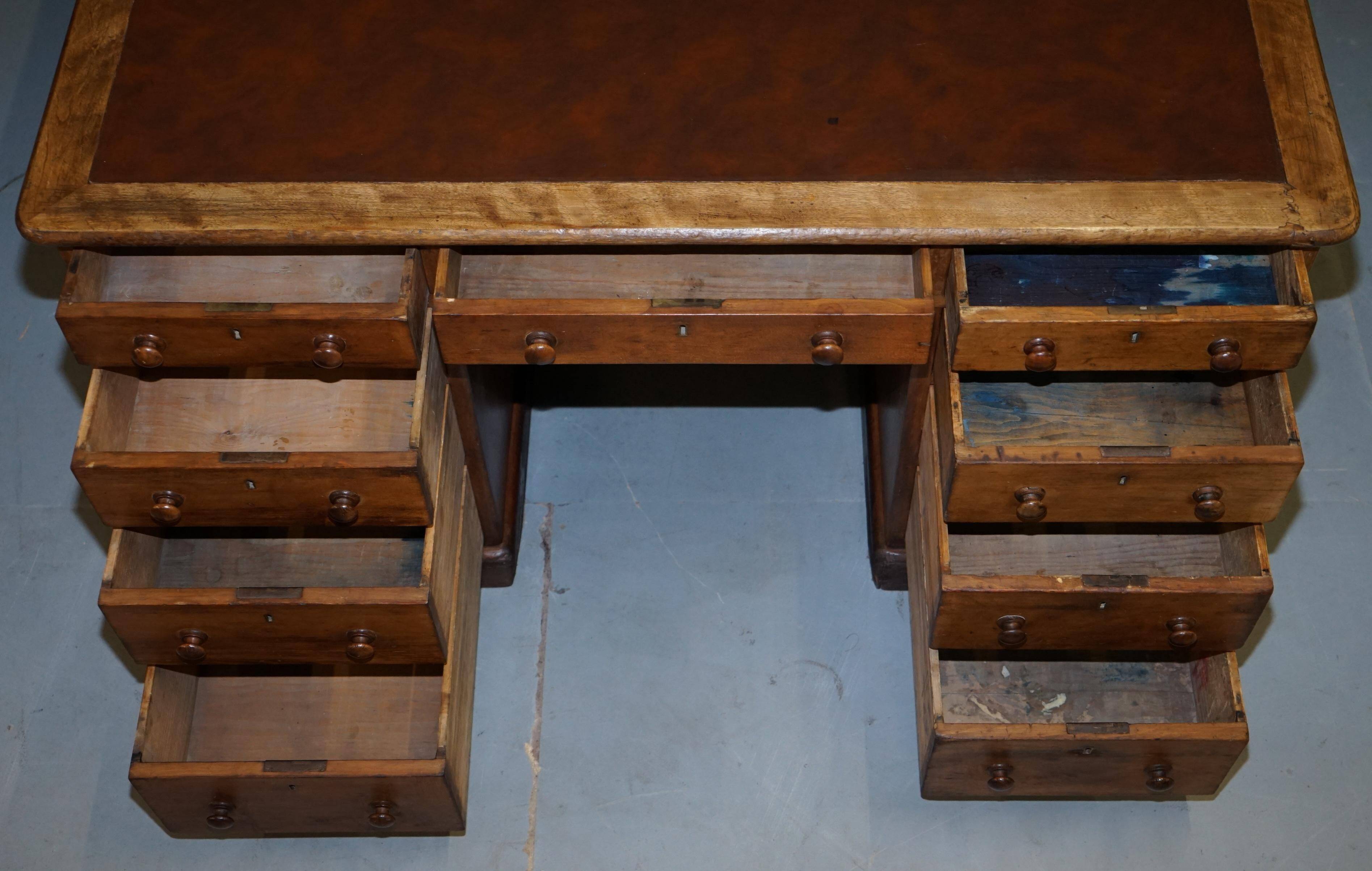 Antique Victorian oak kneehole desk with 18 double-sided drawers.