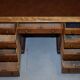 Antique Victorian oak kneehole desk with 18 double-sided drawers.