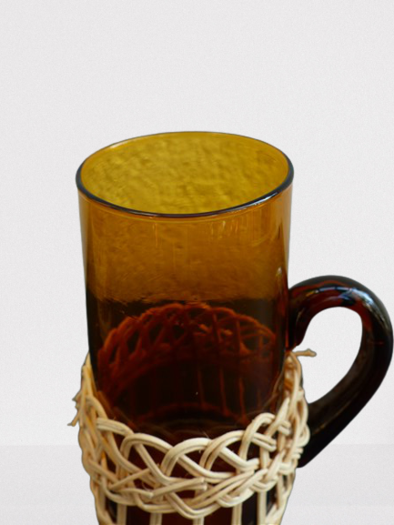 Fruit juice or vintage lemonade service in glass and wicker.