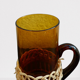 Fruit juice or vintage lemonade service in glass and wicker.