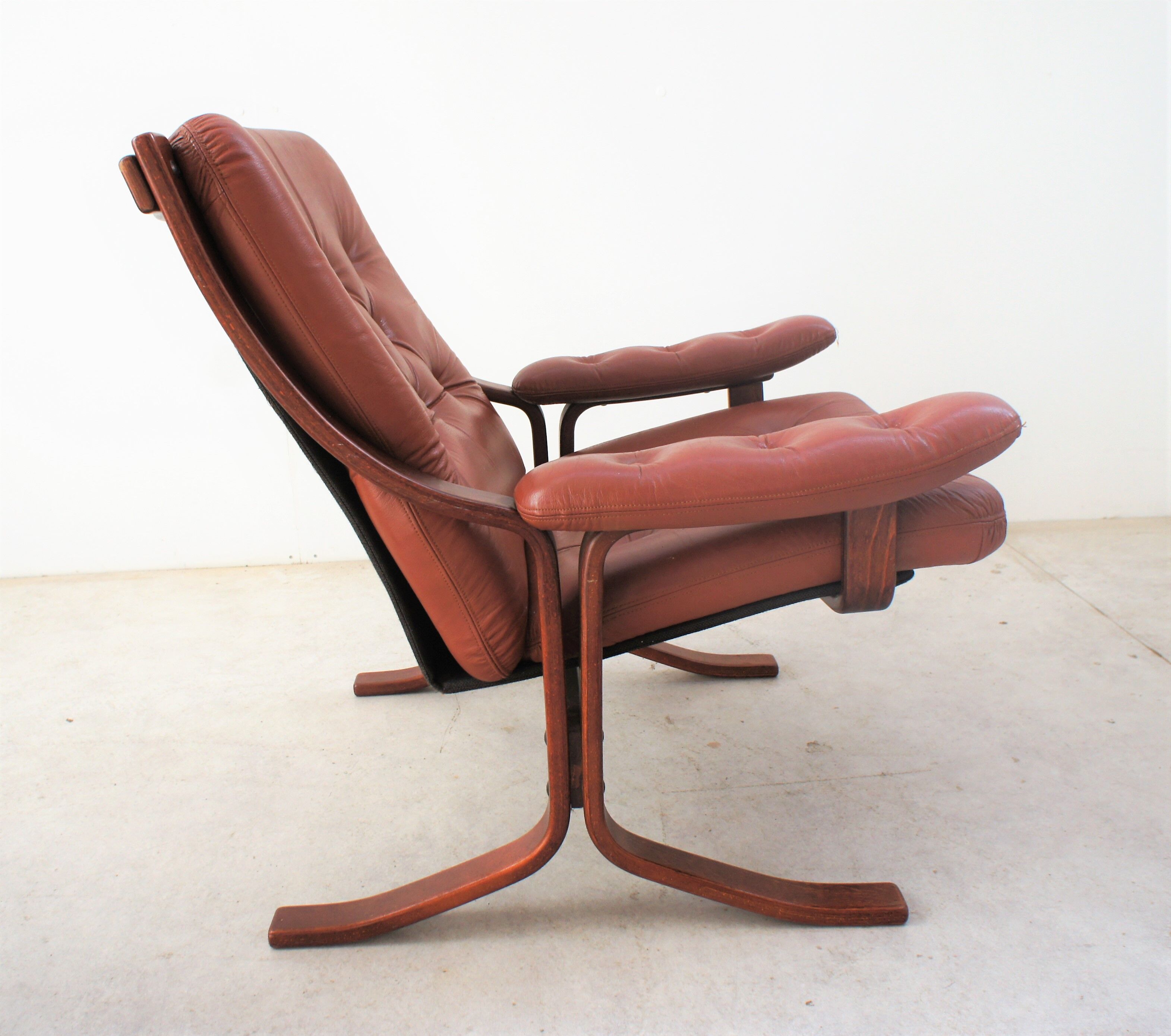 Scandinavian armchair made of wood and cognac leather