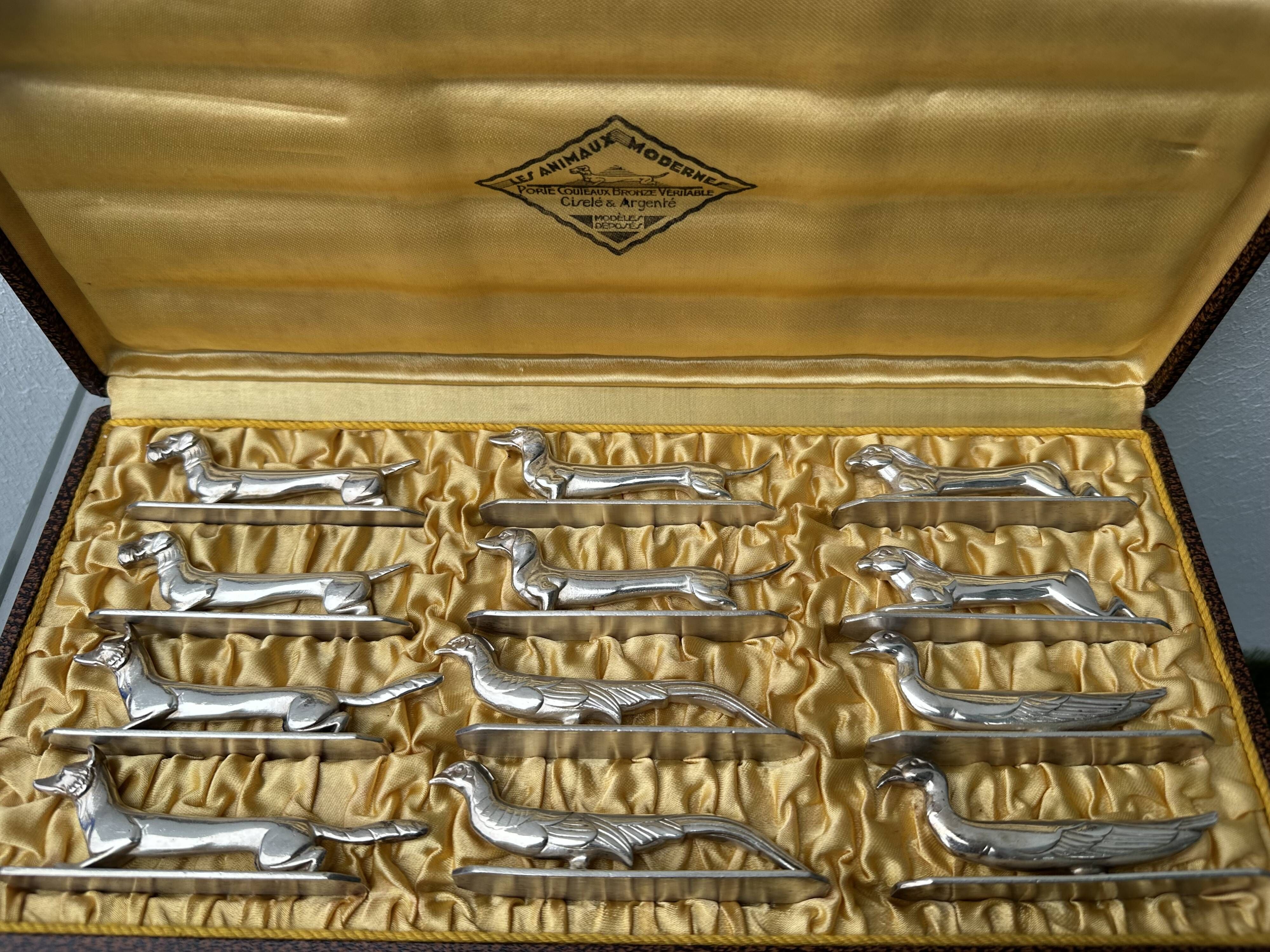 12 antique silver-plated bronze knife rests in modern art deco animal designs.