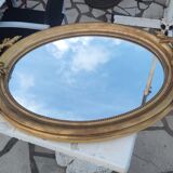 Ovoid mirror with double pediments gilded with leaf circa 1830, 105x66 cm
