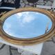 Ovoid mirror with double gilt pediments, circa 1830, 105x66 cm