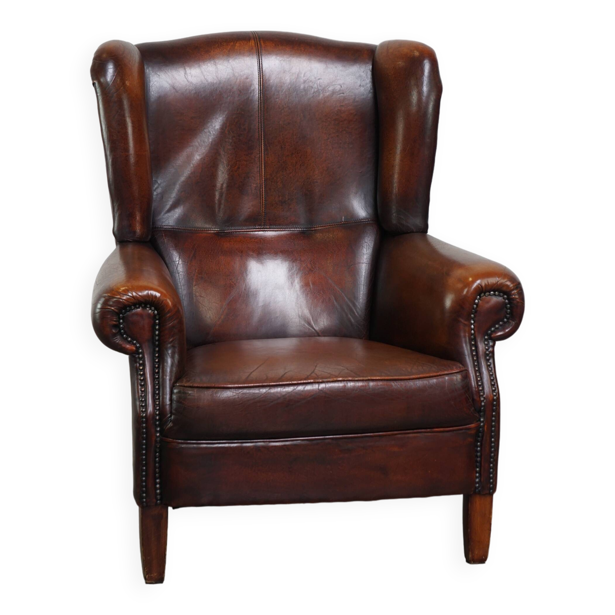 Luxurious sheepskin armchair with a fixed seat cushion and high seating comfort