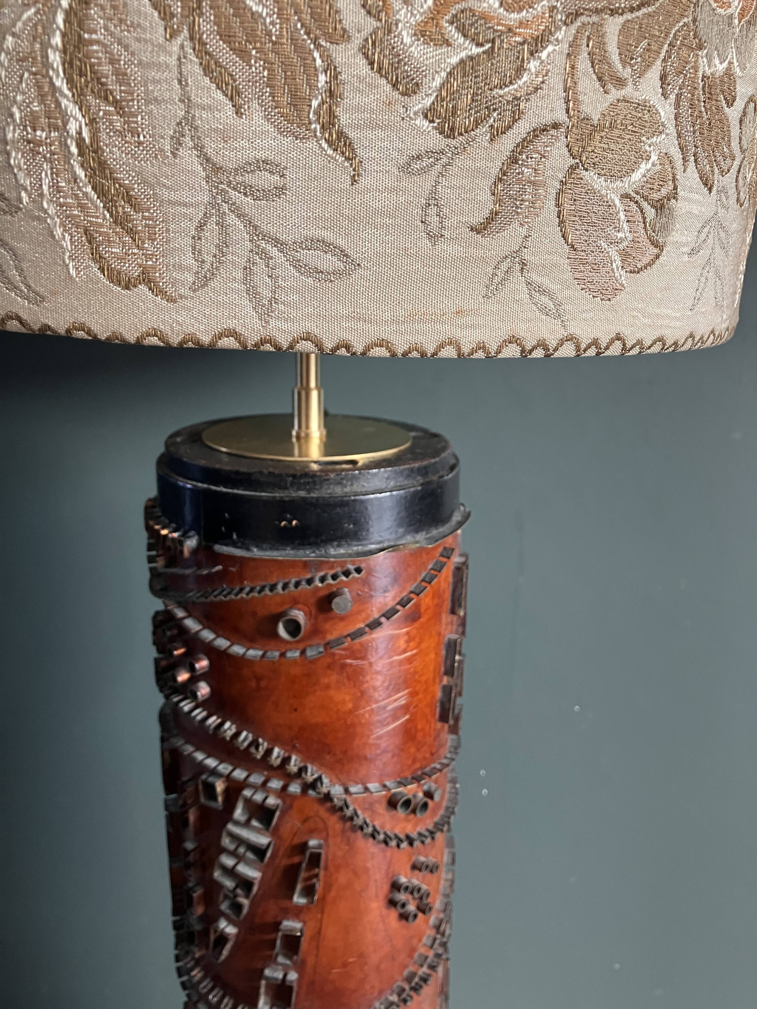 Table lamp with a solid wood printing roll and floral lampshade.
