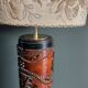 Table lamp with a solid wood printing roll and floral lampshade.