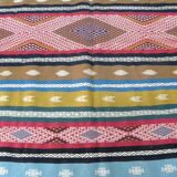 Traditional Berber tribal kilim rug with multicoloured geometric patterns.