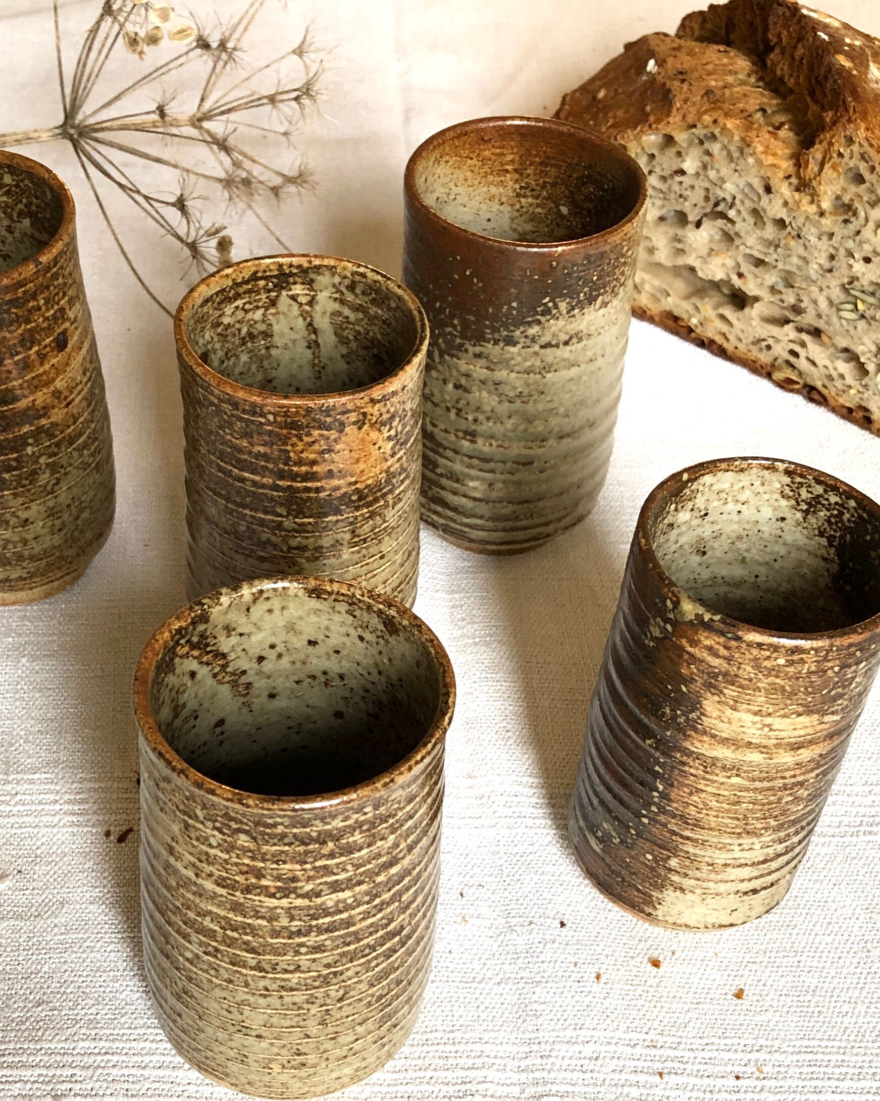 Series of five cups in sandstone