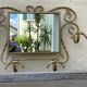 Wall-mounted gilded wrought iron coat rack with mirror