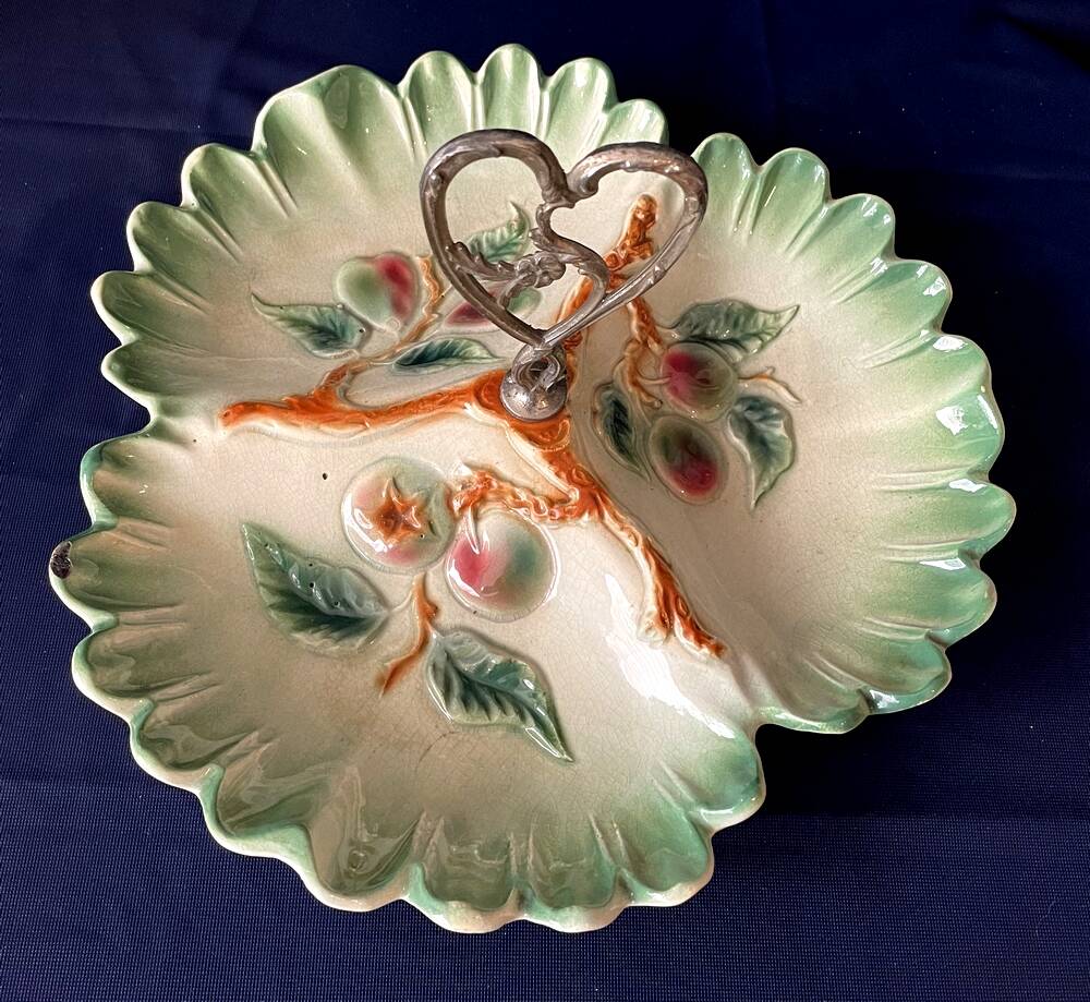 Beggar or servant in barbotine with fruit decoration heart handle